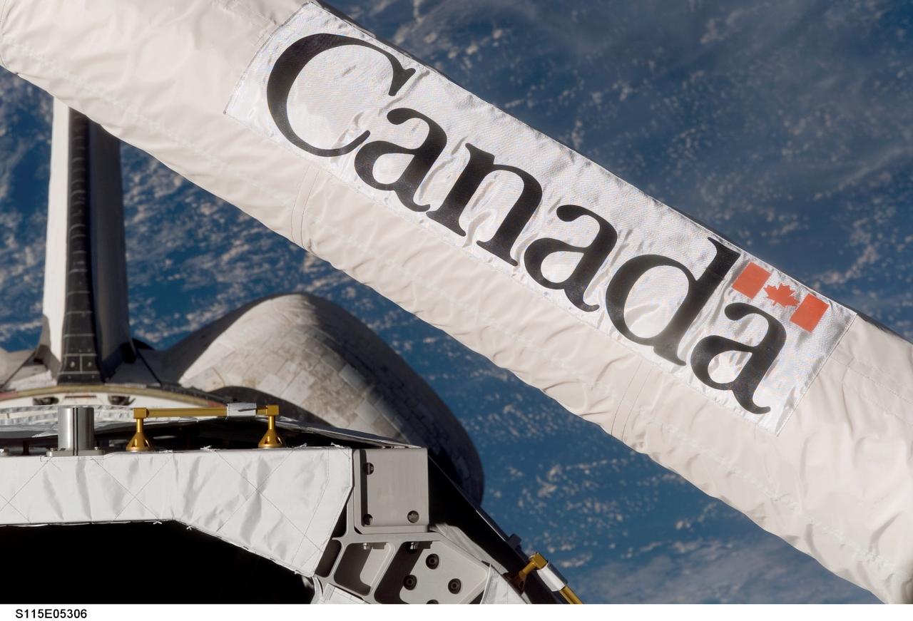 S115-E-05306 (10 Sept. 2006) --- While working to survey the thermal protection system on the Space Shuttle Atlantis, the orbiter boom sensor system (OBSS), attached to the remote manipulator system (RMS) arm was positioned near the shuttle's aft cabin windows. This enabled one of the STS-115 crewmembers to record this digital still close-up image of the Canadian-built system.