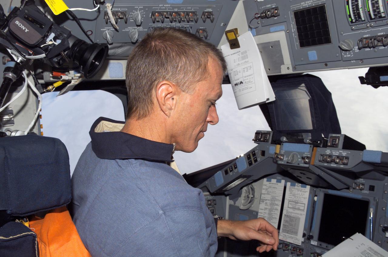 S115-E-05352 (11 Sept. 2006) --- Astronaut Brent W. Jett Jr., STS-115 commander, sits in the port seat on the flight deck of the Space Shuttle Atlantis at it approaches the International Space Station. The subsequent docking will allow the STS-115 astronauts and the Expedition 13 crew to team up for several days of key tasks in space.