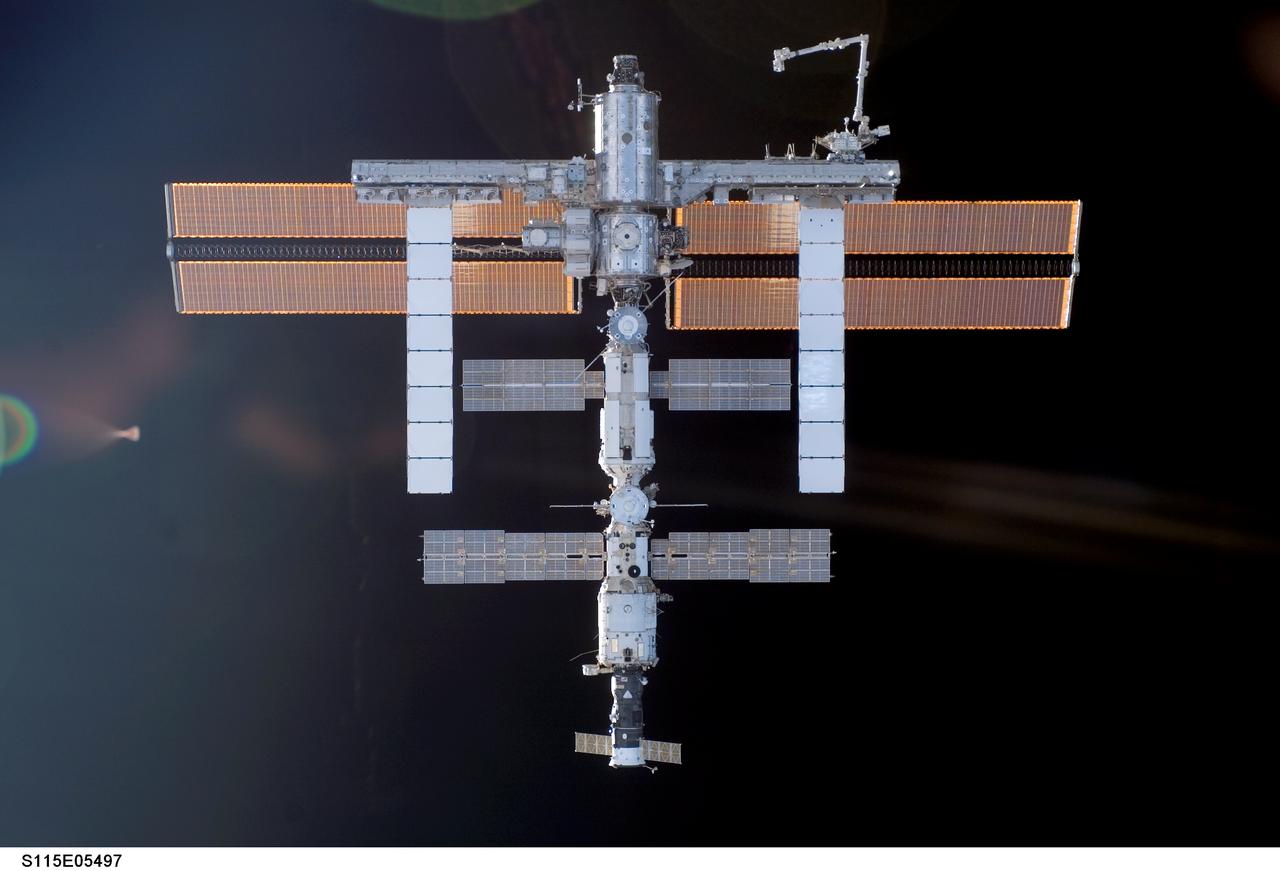 S115-E-05497 (11 Sept. 2006) --- One of the STS-115 crewmembers aboard the Space Shuttle Atlantis took this picture of the International Space Station prior to the docking of the two spacecraft. The subsequent link-up will allow the STS-115 astronauts and the ISS Expedition 13 crew to team up for several days of key tasks in space.