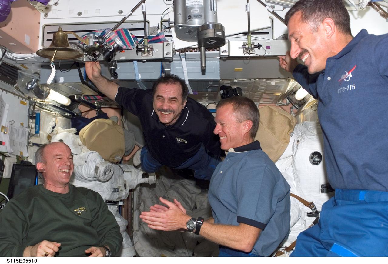 S115-E-05510 (11 Sept. 2006) --- Expedition 13 and STS-115 crewmembers reunite onboard the International Space Station soon after docking. A smiling cosmonaut Pavel Vinogradov, Expedition 13 commander representing Russia's Federal Space Agency, floats into the scene, joining (from left) astronauts Jeffrey N. Williams, Expedition 13 flight engineer and NASA station science officer; Brent W. Jett Jr., STS-115 commander, and Daniel C. Burbank, STS-115 mission specialist.