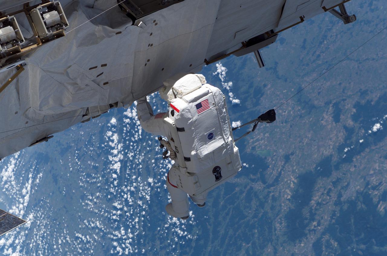 S115-E-05532 (12 Sept. 2006) --- It was "installation day" on the International Space Station on Sept. 12, 2006. The Atlantis and Expedition 13 crews worked on attaching the P3/P4 truss during the first of three scheduled spacewalks by STS-115 shuttle crewmembers. Astronaut Joseph R. Tanner, mission specialist, pictured as he translated along the station hardware, was joined by astronaut Heidemarie M. Stefanyshyn-Piper, mission specialist.