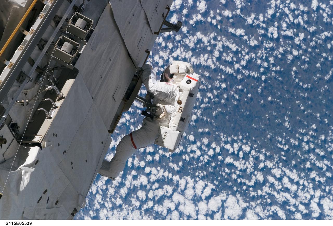 S115-E-05539 (12 Sept. 2006) ---  It was "installation day" on the International Space Station on Sept. 12, 2006.  The Atlantis and Expedition 13 crews worked on attaching the P3/P4 truss during the first of three scheduled spacewalks by  STS-115 shuttle crew members. Astronaut Joseph R. Tanner, mission specialist, pictured as he translated along the station hardware, was joined by astronaut Heidemarie M.  Stefanyshyn-Piper, mission specialist.