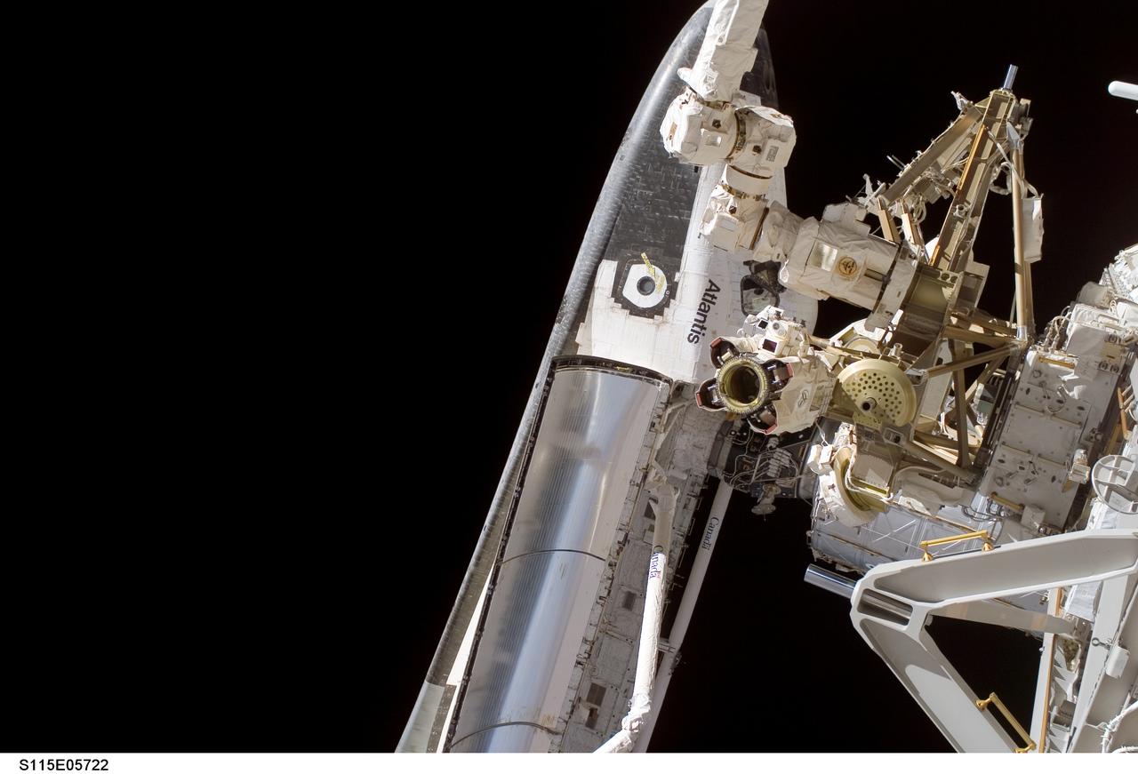 S115-E-05722 (12 Sept. 2006) --- The Space Shuttle Atlantis will remain docked with the International Space Station like this for several more days as the STS-115 and Expedition 13 crewmembers join efforts to resume construction of the International Space Station. This image was taken during the first of three scheduled space walks.