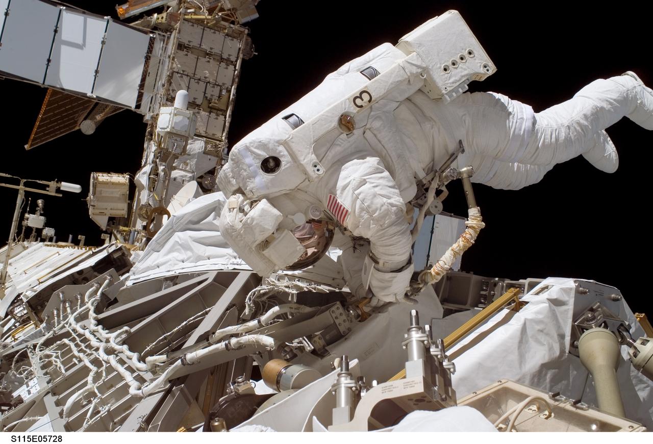 S115-E-05728 (12 Sept. 2006) --- Astronaut Heidemarie M. Stefanyshyn-Piper, STS-115 mission specialist, works with the Solar Alpha Rotary Joint (SARJ) during the Sept. 12 spacewalk, which she shared with astronaut Joseph R. Tanner (out of frame). The two participated in the first of three scheduled STS-115 extravehicular activity (EVA) sessions as the Atlantis astronauts and the Expedition 13 crew members join efforts this week to resume construction of the International Space Station.