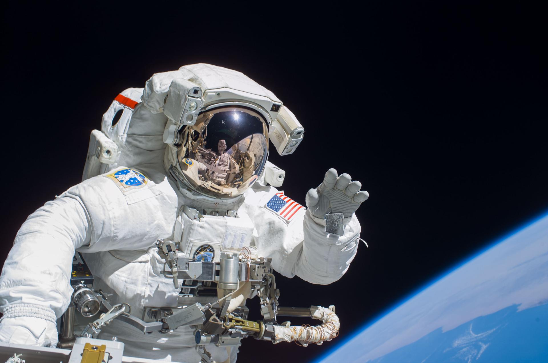 Astronaut Joseph R. Tanner, STS-115 mission specialist, waves toward the digital still camera of his spacewalk colleague, astronaut Heidemarie M. Stefanyshyn-Piper as the two share extravehicular activity (EVA) duties during the first of three scheduled spacewalks. The STS-115 astronauts and the Expedition 13 crewmembers are joining efforts this week to resume construction of the International Space Station.