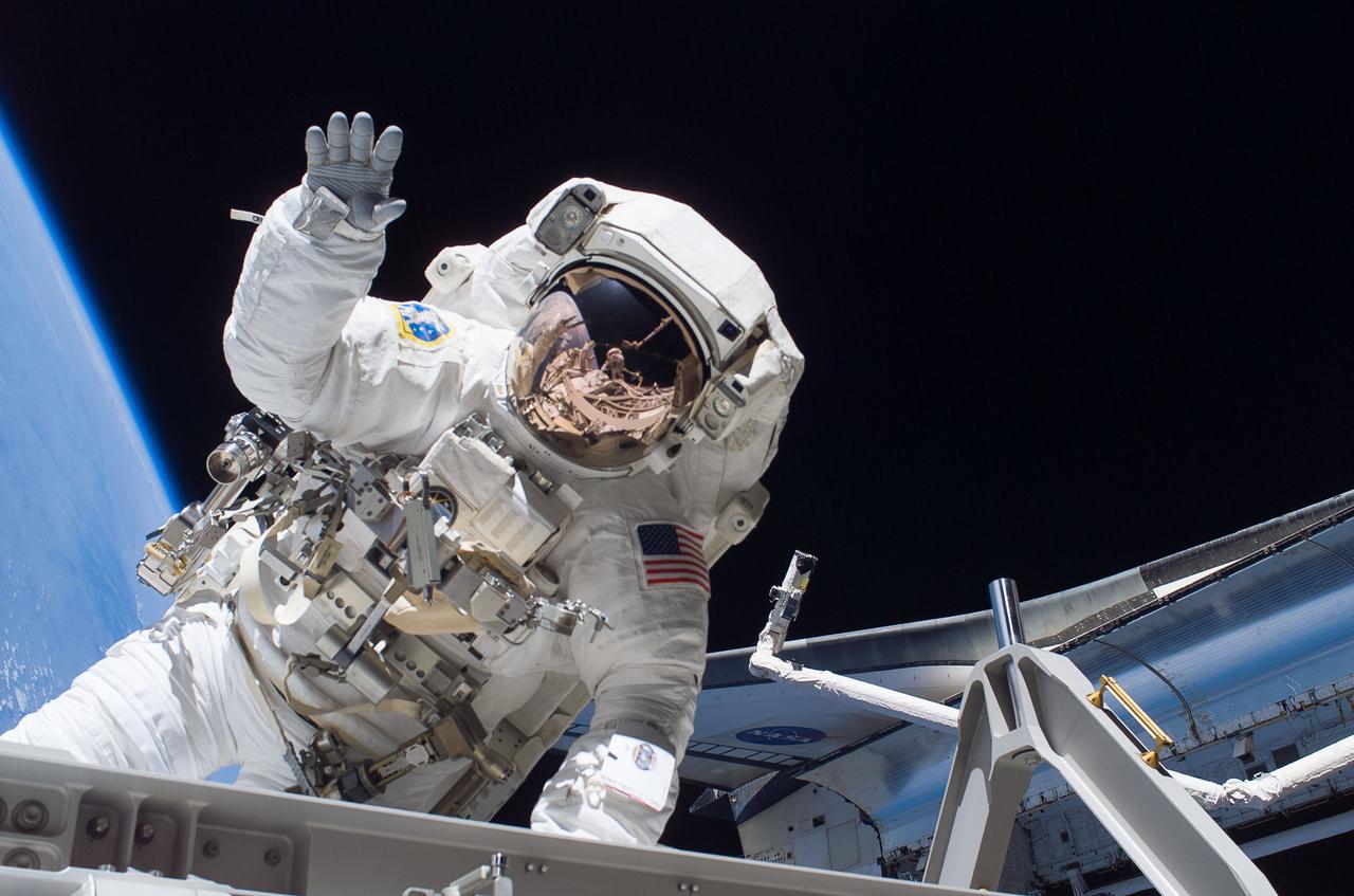 S115-E-05760 (12 Sept. 2006) --- Astronaut Heidemarie M. Stefanyshyn-Piper, STS-115 mission specialist, waves to the camera while participating in the first of three sessions of extravehicular activity (EVA) as construction resumes on the International Space Station.