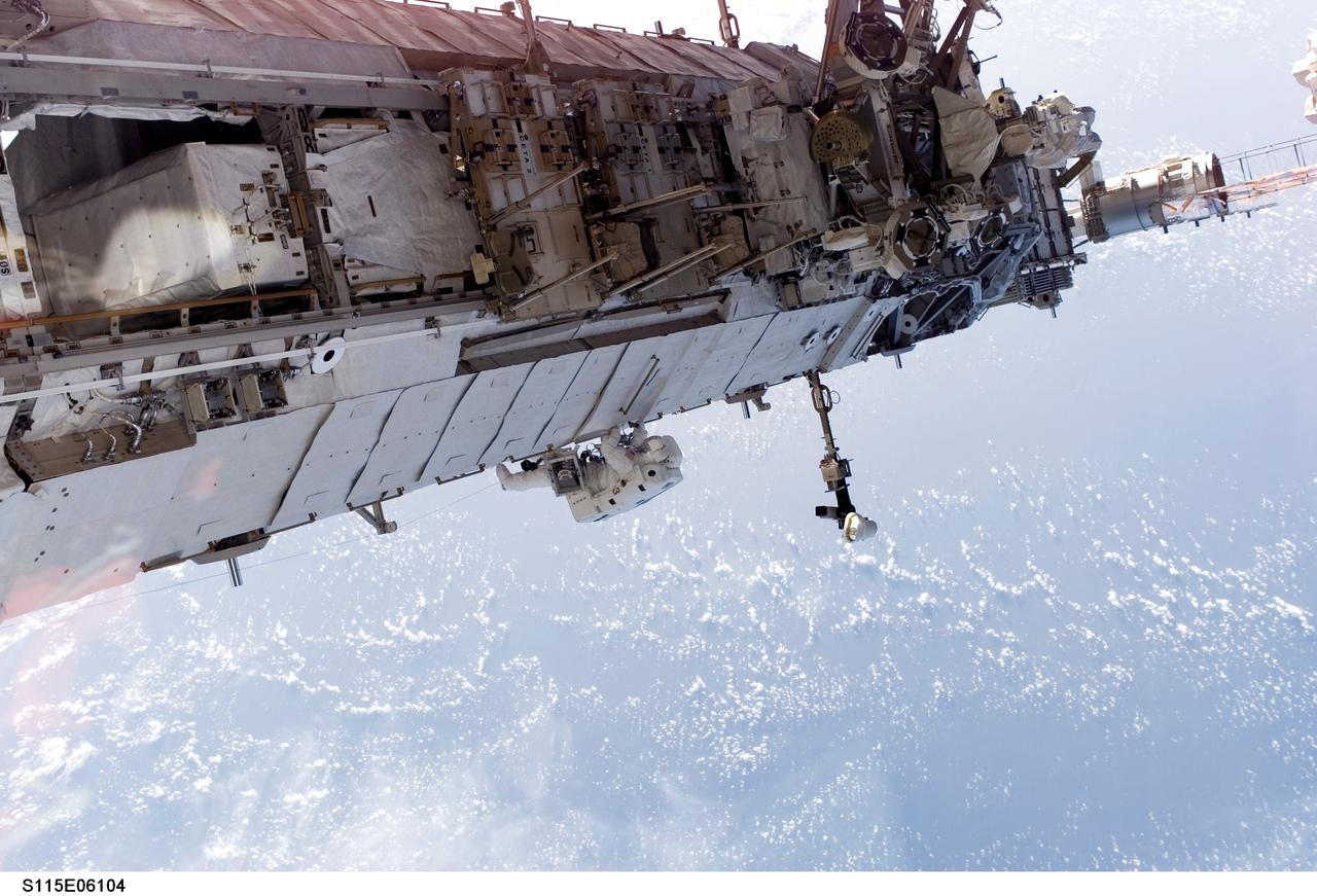 S115-E-06104 (15 Sept. 2006) --- In the center of this panoramic scene of new hardware on the International Space Station, astronaut Heidemarie M. Stefanyshyn-Piper, mission specialist, participates in the final of three scheduled STS-115 space walks.