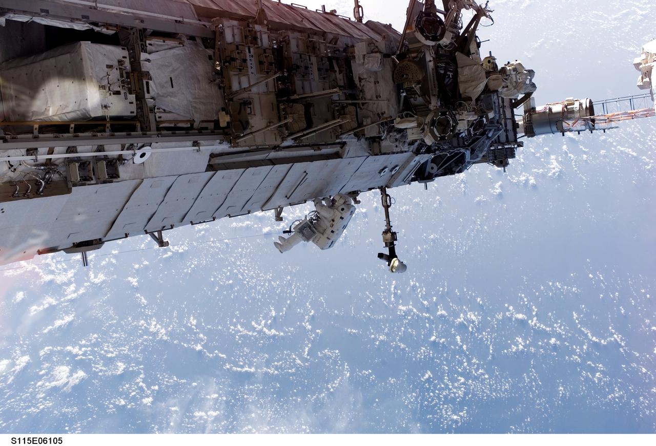 S115-E-06105 (15 Sept. 2006) --- In the center of this panoramic scene of new hardware on the International Space Station, astronaut Heidemarie M. Stefanyshyn-Piper, mission specialist, participates in the final of three scheduled STS-115 space walks.  Her partner on both of her two spacewalks this week is astronaut Joseph R. Tanner, out of frame.
