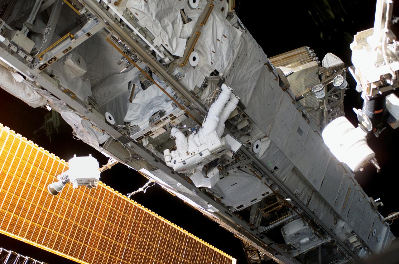 S115-E-06162 (15 Sept. 2006) --- This wide scene of the final STS-115 extravehicular activity has been quite typical this week, as the Space Shuttle Atlantis crewmembers and the International Space Station occupants join efforts to resume construction on the orbital outpost. Astronaut Heidemarie M. Stefanyshyn-Piper, mission specialist, can be seen working at one of the ISS trusses in the center of the photo.