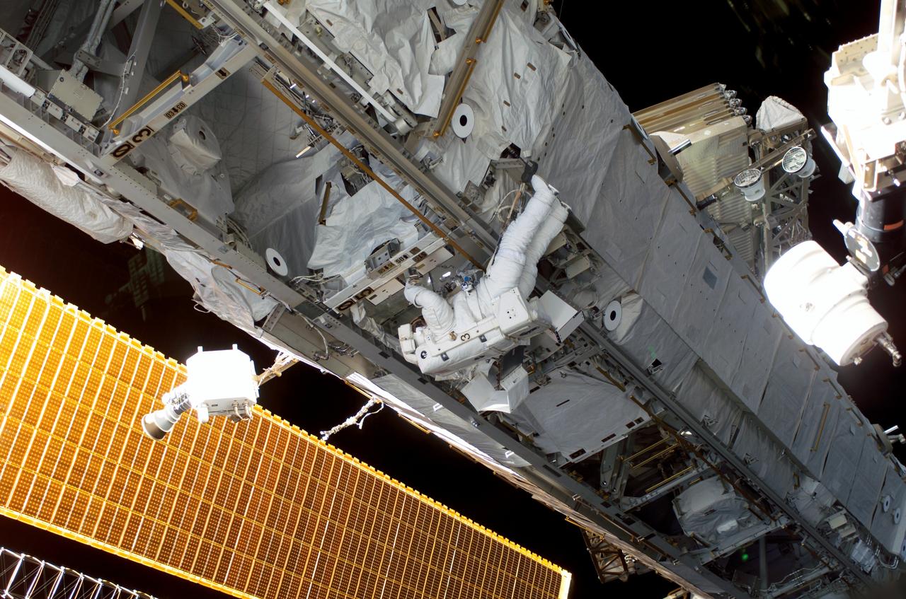 S115-E-06165 (15 Sept. 2006) --- This wide scene of the final STS-115 extravehicular activity has been quite typical this week, as the Atlantis crewmembers and the International Space Station occupants join efforts to resume construction on the orbital outpost. Astronaut Heidemarie M. Stefanyshyn-Piper can be seen working at one of the ISS trusses in the center of the photo.