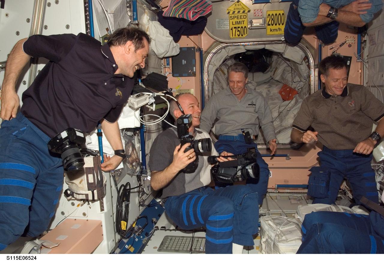 S115-E-06524 (16 Sept. 2006) --- STS-115 and Expedition 13 crewmembers enjoy a light moment in the Unity node of the International Space Station while Space Shuttle Atlantis was docked with the station. From the left are cosmonaut Pavel V. Vinogradov, Expedition 13 commander representing Russia's Federal Space Agency; astronauts Jeffrey N. Williams, NASA space station science officer and flight engineer; Thomas Reiter, flight engineer representing the European Space Agency (ESA); Christopher J. Ferguson, STS-115 pilot; Daniel C. Burbank (partially out of frame) and Heidemarie M. Stefanyshyn-Piper (partially out of frame), both STS-115 mission specialists.
