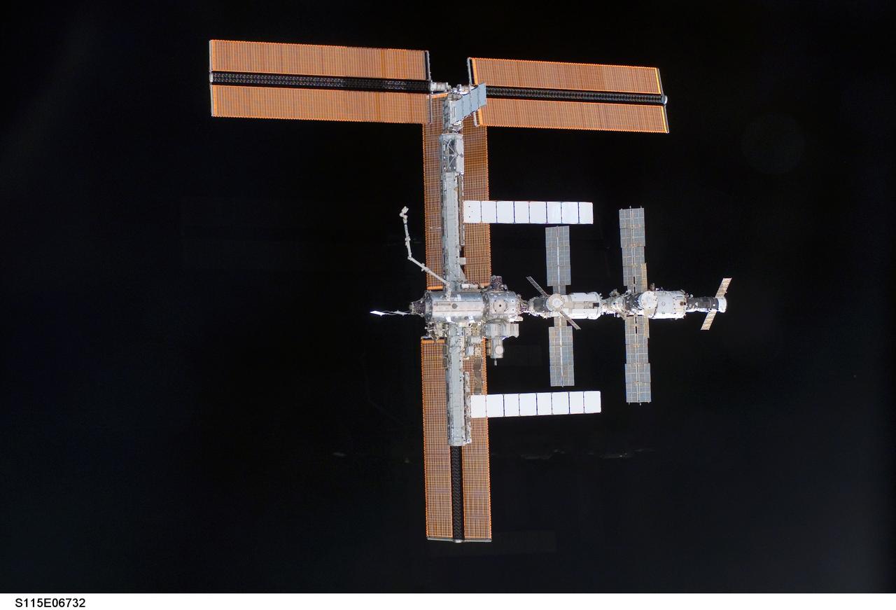 S115-E-06732 (17 Sept. 2006) --- This view of the International Space Station, backdropped against  the blackness of space, was taken shortly after the Space Shuttle Atlantis undocked from the orbital outpost at 7:50 a.m. CDT.  The unlinking completed six days, two hours and two minutes of joint operations with the station crew.  Atlantis left the station with a new, second pair of 240-foot solar wings, attached to a new 17.5-ton section of truss with batteries, electronics and a giant rotating joint. The new solar arrays eventually will double the station's onboard power when their electrical systems are brought online during the next shuttle flight, planned for launch in December.