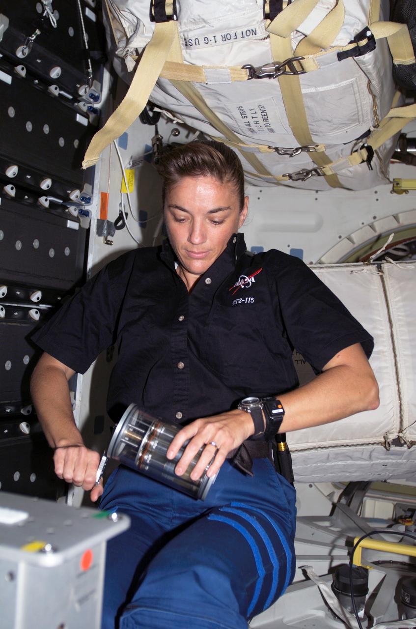 S115-E-07273 (9-21 Sept. 2006) --- Astronaut Heidemarie M. Stefanyshyn-Piper, STS-115 mission specialist, works with the Yeast-Group Activation Packs (Yeast-GAP) on the middeck of Space Shuttle Atlantis. Yeast-GAP experiment studies the effects of genetic changes of yeast cells exposed to the space environment. The results will help scientists to understand how cells respond to radiation and microgravity.