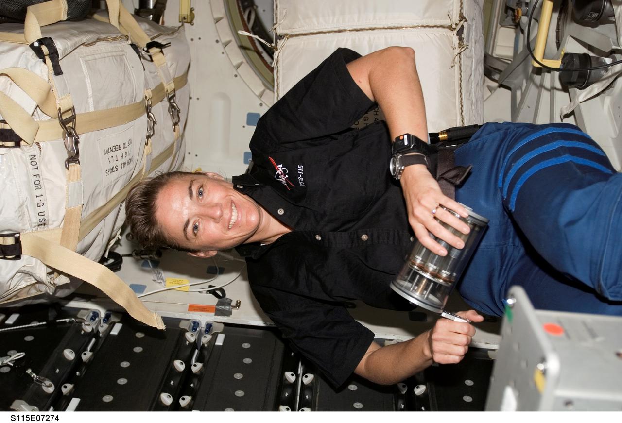 S115-E-07274 (9-21 Sept. 2006) --- Astronaut Heidemarie M. Stefanyshyn-Piper, STS-115 mission specialist, works with the Yeast-Group Activation Packs (Yeast-GAP) on the middeck of Space Shuttle Atlantis. Yeast-GAP experiment studies the effects of genetic changes of yeast cells exposed to the space environment. The results will help scientists to understand how cells respond to radiation and microgravity.