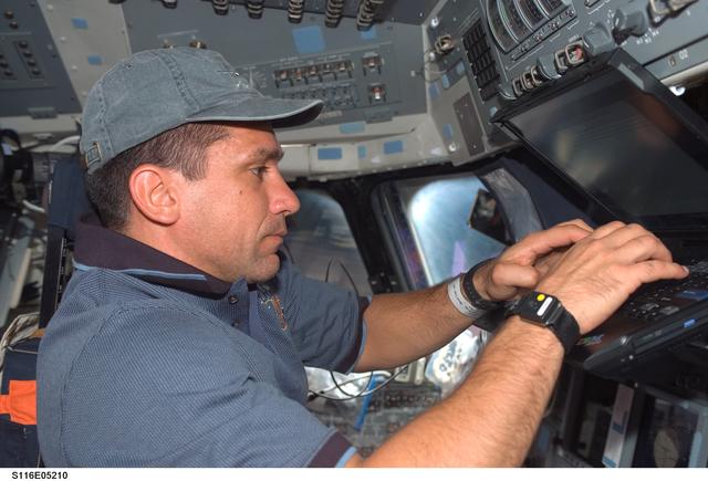 NASA image: STS-116 Pilot Oefelin uses laptop computer in the FD on Space Shuttle Discovery