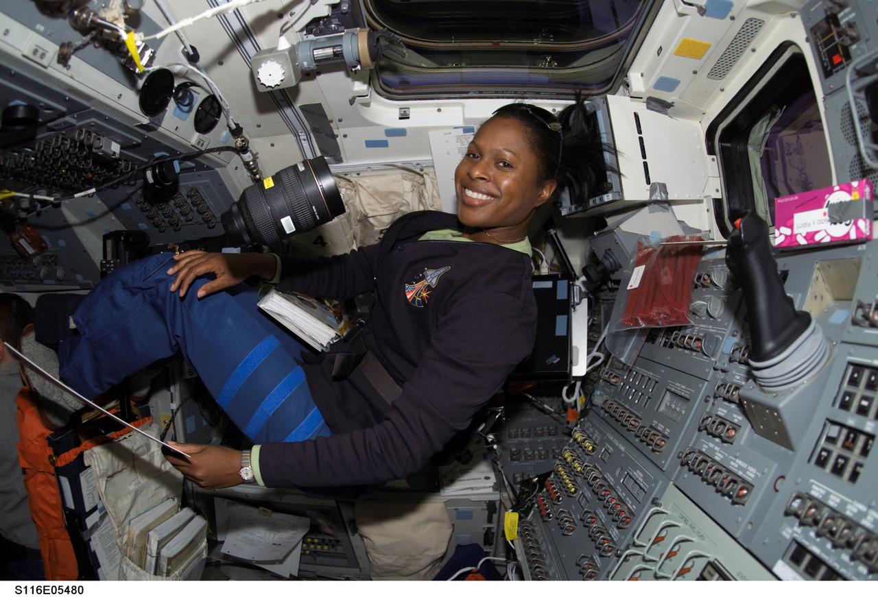 S116-E-05480 (11 Dec. 2006) --- Astronaut Joan E. Higginbotham, STS-116 mission specialist, settles in for a task on the aft flight deck of Space Shuttle Discovery during flight day three activities.