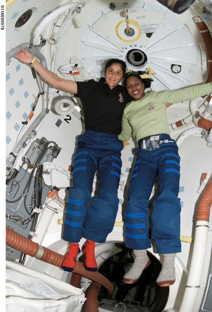 NASA image: Crewmembers Williams and Higginbotham in the hatch area of Space Shuttle Discovery
