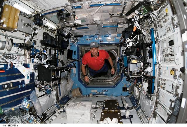 NASA image: STS-116 Pilot Oefelein floats through the U.S. Laboratory during Joint Operations
