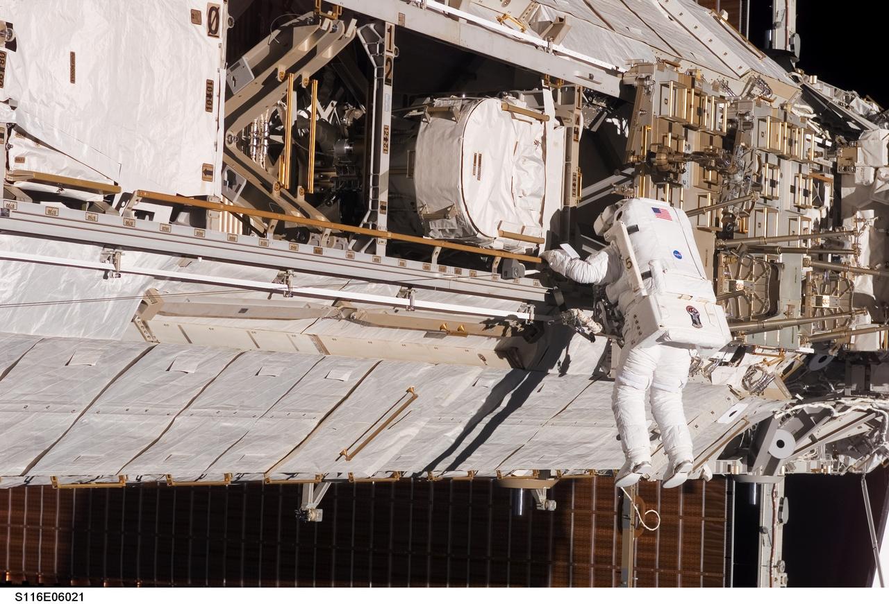 S116-E-06021 (12 Dec. 2006) --- European Space Agency (ESA) astronaut Christer Fuglesang, STS-116 mission specialist, participates in the mission's first of three planned sessions of extravehicular activity (EVA) as construction resumes on the International Space Station. Astronaut Robert L. Curbeam, Jr. (out of frame), mission specialist, also participated in the 6-hour, 36-minute spacewalk.