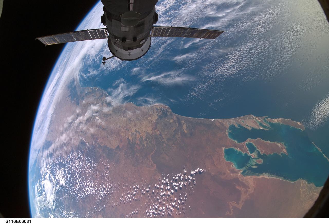 S116-E-06081 (13 Dec. 2006) -- Backdropped against a colorful part of Earth, Progress 23 supply vehicle docked to the Zvezda Service Module's aft port of International Space Station, is featured in this image photographed by a STS-116 crewmember while Space Shuttle Discovery was docked with the station. Shark Bay, Australia is visible at lower right.