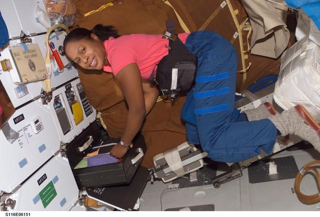 NASA image: STS-116 MS Higginbotham retrieves items from a drawer in the MDDK on Space Shuttle Discovery