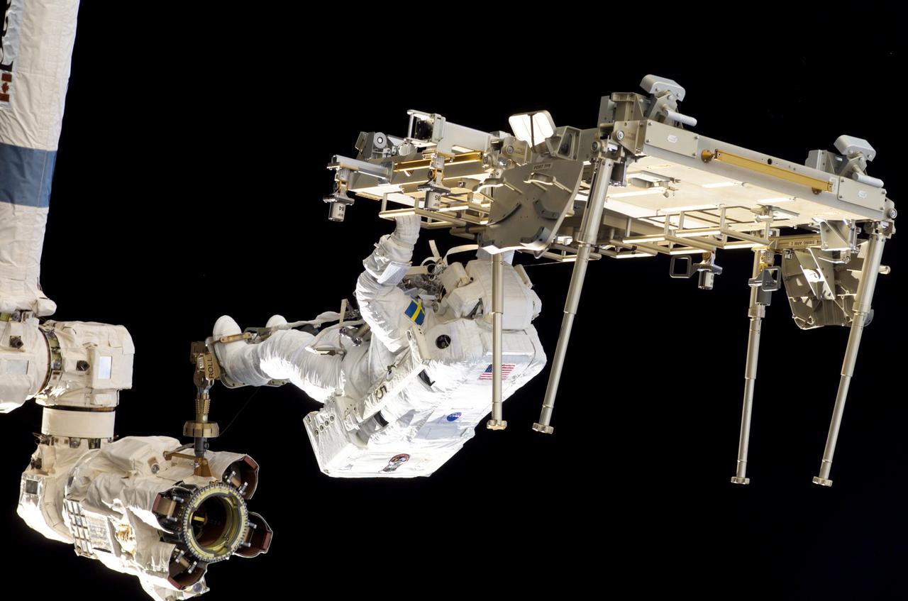 S116-E-06275 (14 Dec. 2006) --- With his feet secured on the Canadarm2, European Space Agency astronaut Christer Fuglesang, STS-116 mission specialist, works to relocate one of the two Crew Equipment Translation Aid (CETA) carts during EVA 2 on Dec. 14. Astronaut Robert L. Curbeam Jr., who is sharing two spacewalks with Fuglesang on this flight, is out of frame.