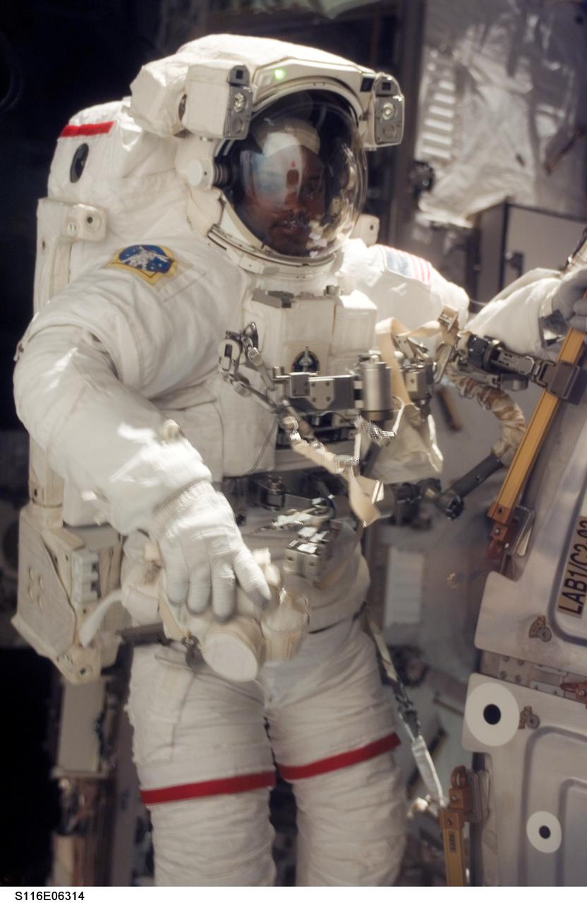 S116-E-06314 (14 Dec. 2006) --- Astronaut Robert L. Curbeam, Jr., STS-116 mission specialist, participates in the mission's second of three planned sessions of extravehicular activity (EVA) as construction resumes on the International Space Station. European Space Agency (ESA) astronaut Christer Fuglesang (out of frame), mission specialist, also participated in the spacewalk.