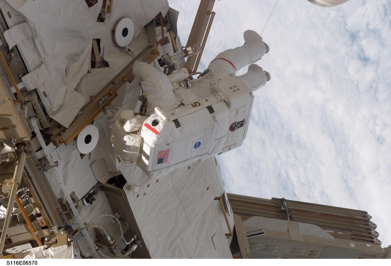 S116-E-06570 (16 Dec. 2006) --- Astronaut Robert L. Curbeam, Jr., STS-116 mission specialist, participates in the mission's third planned session of extravehicular activity (EVA) as construction resumes on the International Space Station. Astronaut Sunita L. Williams, (out of frame), Expedition 14 flight engineer, also participated in the 7-hour, 31-minute spacewalk.