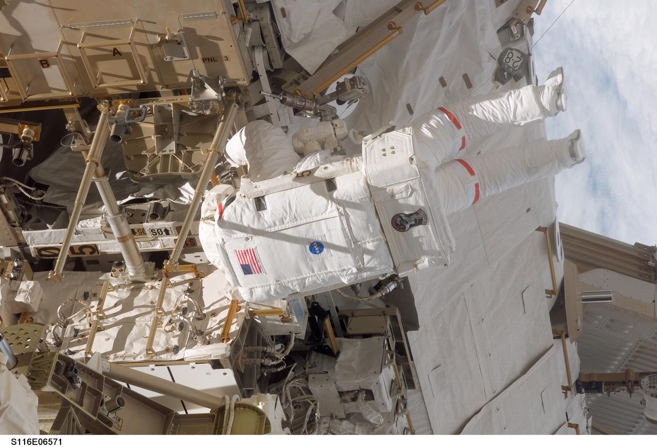 S116-E-06571 (16 Dec. 2006) --- Astronaut Robert L. Curbeam, Jr., STS-116 mission specialist, participates in the mission's third planned session of extravehicular activity (EVA) as construction resumes on the International Space Station. Astronaut Sunita L. Williams, (out of frame), Expedition 14 flight engineer, also participated in the 7-hour, 31-minute spacewalk.