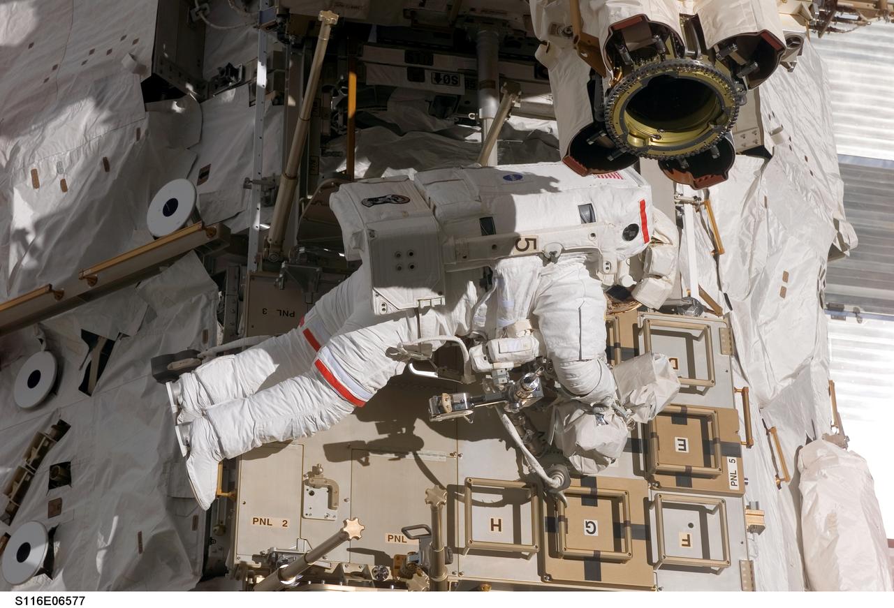 S116-E-06577 (16 Dec. 2006) --- Astronaut Robert L. Curbeam, Jr., STS-116 mission specialist, participates in the mission's third planned session of extravehicular activity (EVA) as construction resumes on the International Space Station. Astronaut Sunita L. Williams, (out of frame), Expedition 14 flight engineer, also participated in the 7-hour, 31-minute spacewalk.