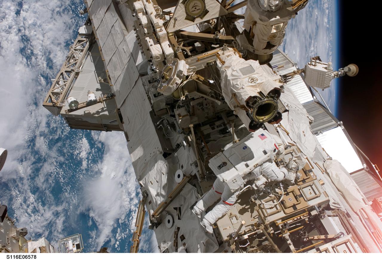 S116-E-06578 (16 Dec. 2006) --- Astronaut Robert L. Curbeam, Jr., STS-116 mission specialist, participates in the mission's third planned session of extravehicular activity (EVA) as construction resumes on the International Space Station. Astronaut Sunita L. Williams, (out of frame), Expedition 14 flight engineer, also participated in the 7-hour, 31-minute spacewalk.
