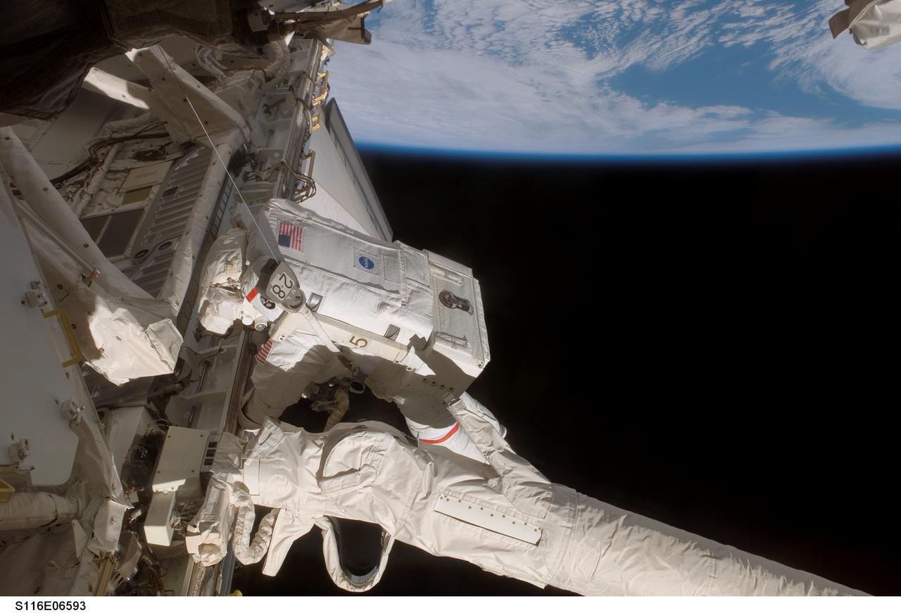 S116-E-06593 (16 Dec. 2006) --- Astronaut Robert L. Curbeam, Jr., STS-116 mission specialist, participates in the mission's third planned session of extravehicular activity (EVA) as construction resumes on the International Space Station. Astronaut Sunita L. Williams, (out of frame), Expedition 14 flight engineer, also participated in the 7-hour, 31-minute spacewalk.