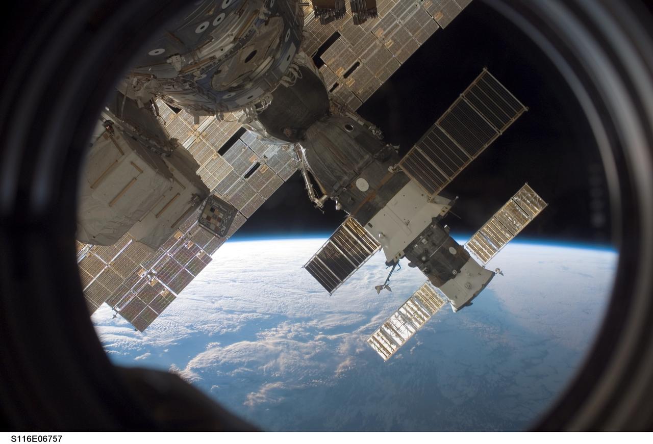 S116-E-06757 (17 Dec. 2006) --- The docked Soyuz 13 (TMA-9) (foreground) and Progress 22 resupply vehicle are featured in this image photographed by a STS-116 crewmember from a window on the International Space Station while Space Shuttle Discovery was docked with the station. The blackness of space and Earth's horizon provide the backdrop for the scene.