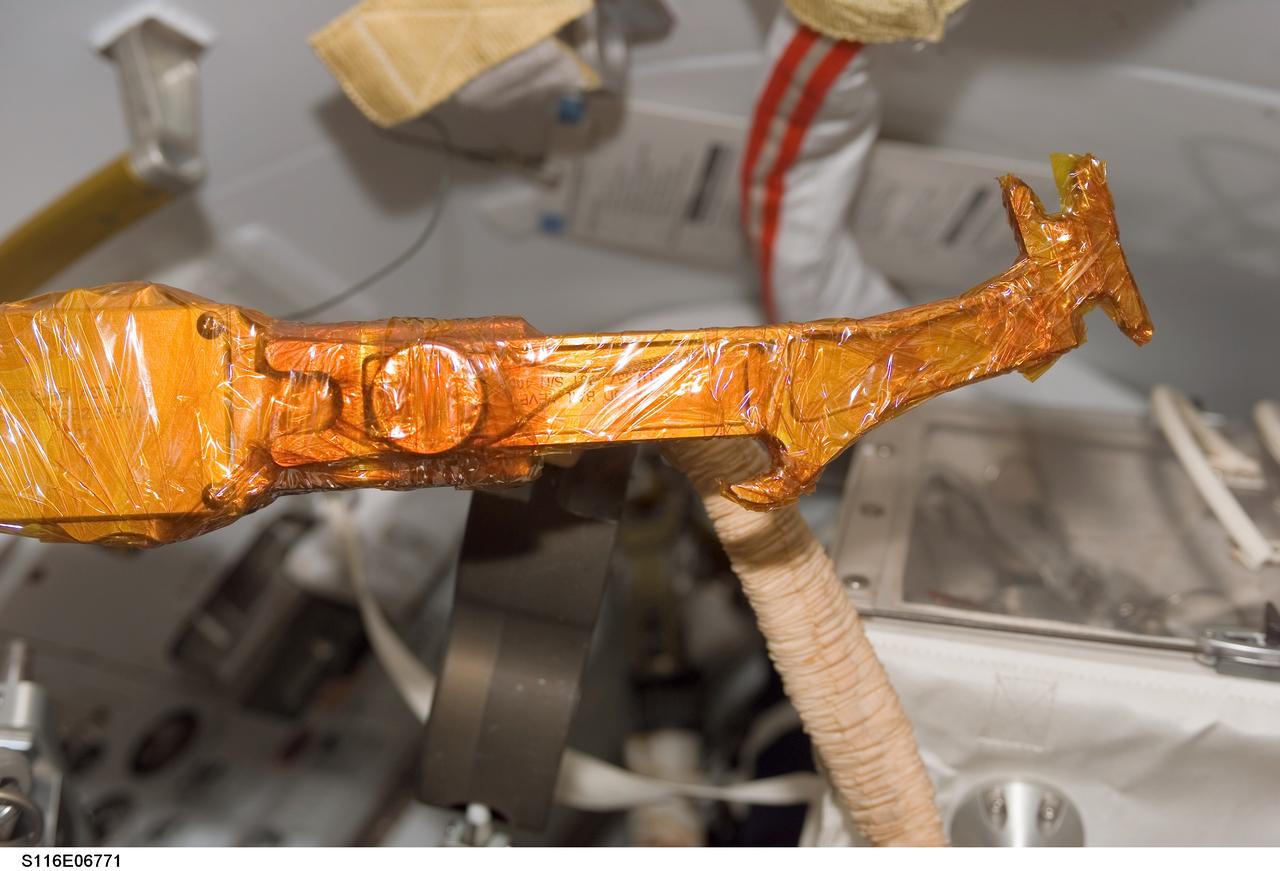 S116-E-06771 (18 Dec. 2006) --- A view of a bail drive lever and cheater bar assembly wrapped in insulating tape onboard Space Shuttle Discovery, scheduled for use during STS-116 extravehicular activity (EVA) as construction resumes on the International Space Station.