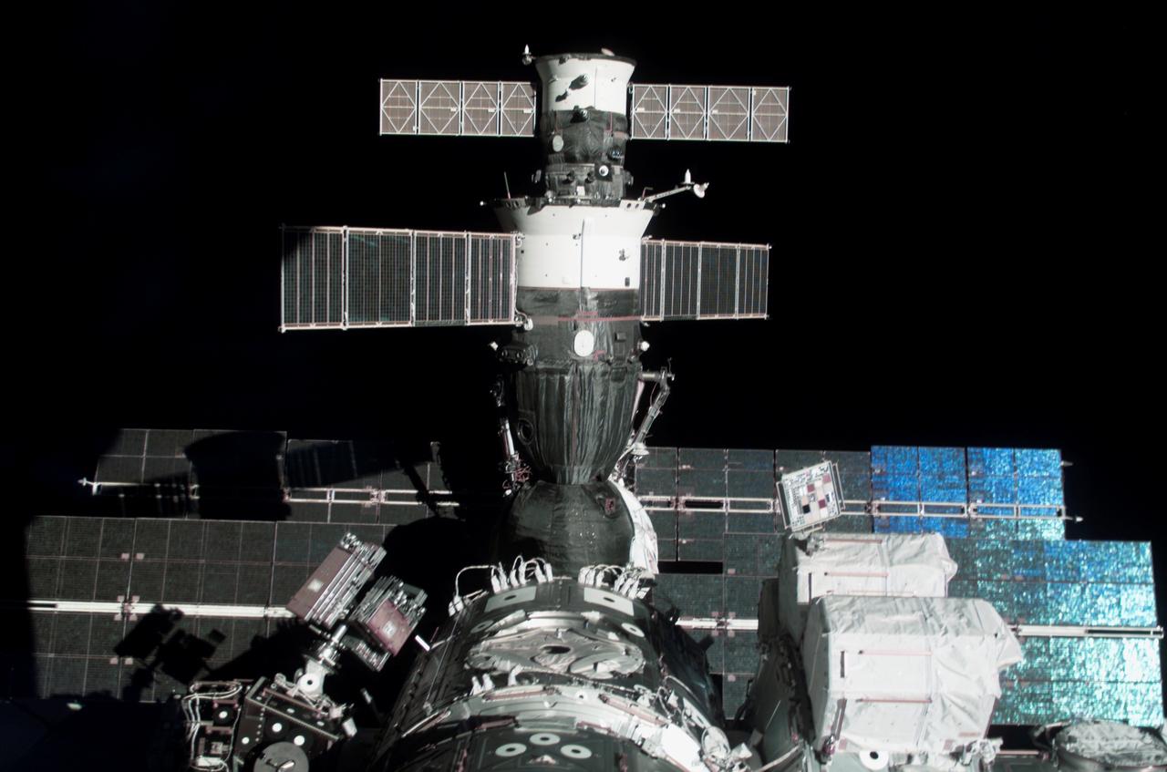 S116-E-06794 (17 Dec. 2006) --- The docked Soyuz 13 (TMA-9) (foreground) and Progress 22 resupply vehicle are featured in this image photographed by a STS-116 crewmember from a window on the International Space Station while Space Shuttle Discovery was docked with the station. The blackness of space provides the backdrop for the scene.