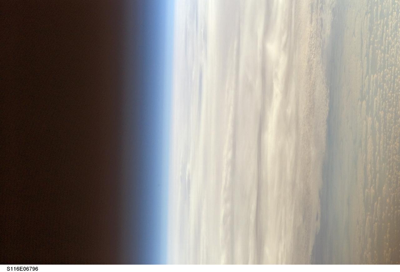 S116-E-06796 (17 Dec. 2006) --- A blanket of heavy cloud cover, airglow and the blackness of space are featured in this image photographed by a STS-116 crewmember on the International Space Station while Space Shuttle Discovery was docked with the station.