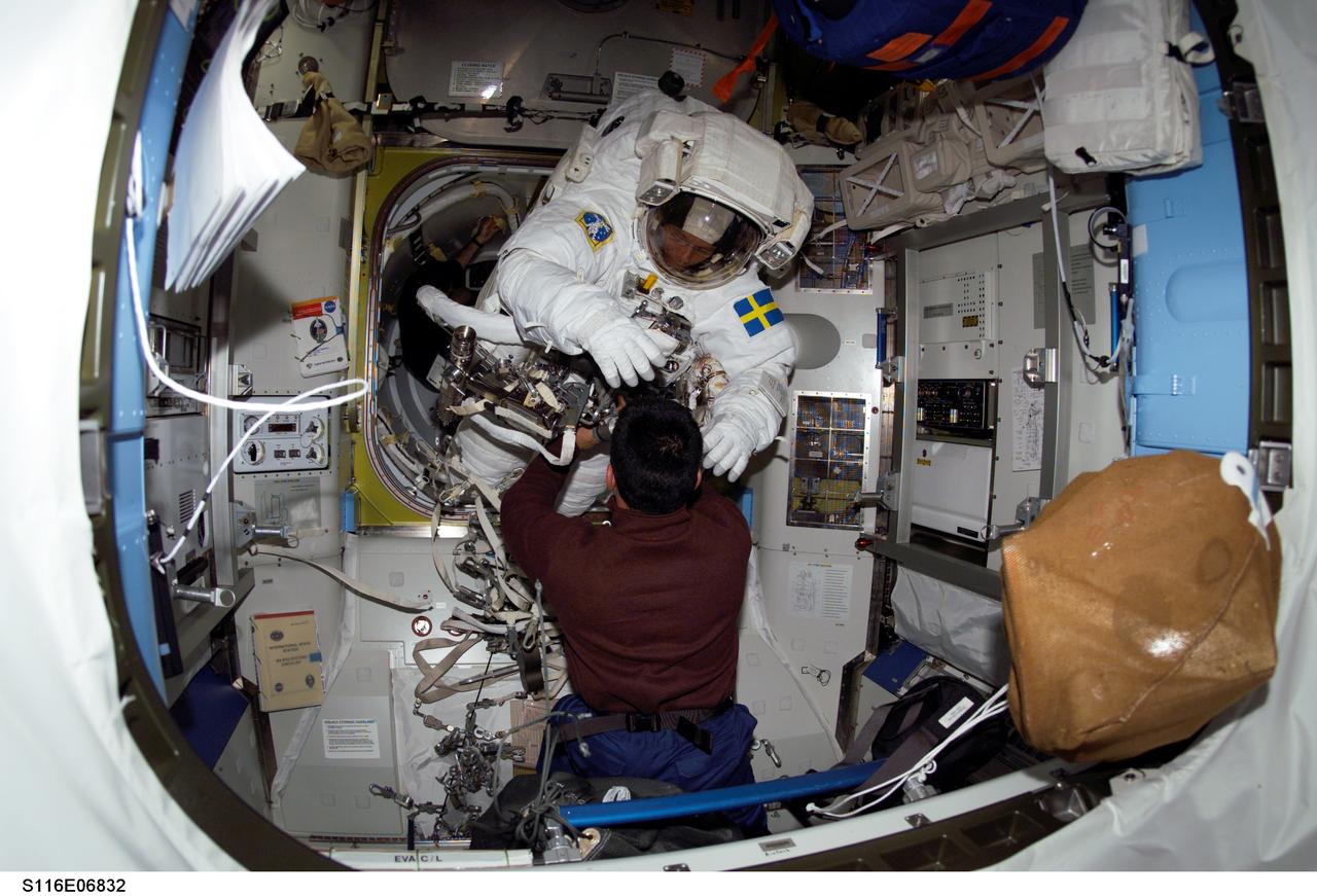 S116-E-06832 (18 Dec. 2006) --- European Space Agency (ESA) astronaut Christer Fuglesang, STS-116 mission specialist, moves into the outer section of the Quest Airlock of the International Space Station as he prepares for the mission's fourth session of extravehicular activity (EVA) while Space Shuttle Discovery was docked with the station. Astronaut William A. (Bill) Oefelein, pilot, assisted Fuglesang.