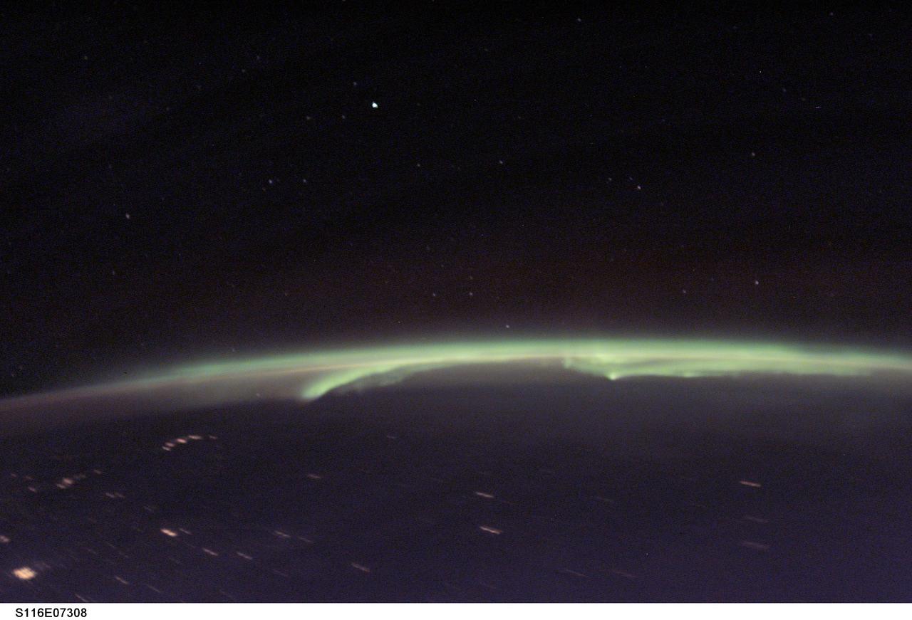 S116-E-07308 (19 Dec. 2006) --- The Aurora Borealis, also known as "northern lights", is featured in this photograph taken by a STS-116 crew member onboard Space Shuttle Discovery during flight day 11 activities. The long exposure on the digital still camera enabled the astronaut to capture stars and city lights.