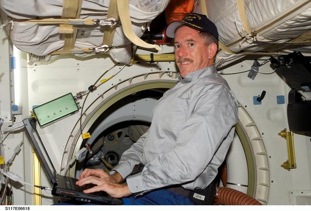 NASA image: Reilly works at laptop computer in the MDDK on STS-117 Space Shuttle Atlantis