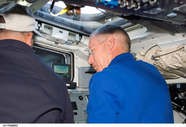 NASA image: Archambault and Forrester work at control panel on the aft FD of STS-117 Space Shuttle Atlantis