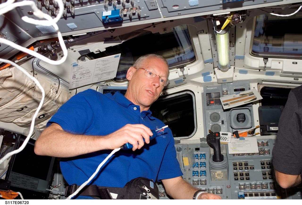 S117-E-06720 (9 June 2007) --- Astronaut Patrick Forrester, STS-117 mission specialist, uses a communication system on the aft flight deck of Space Shuttle Atlantis.