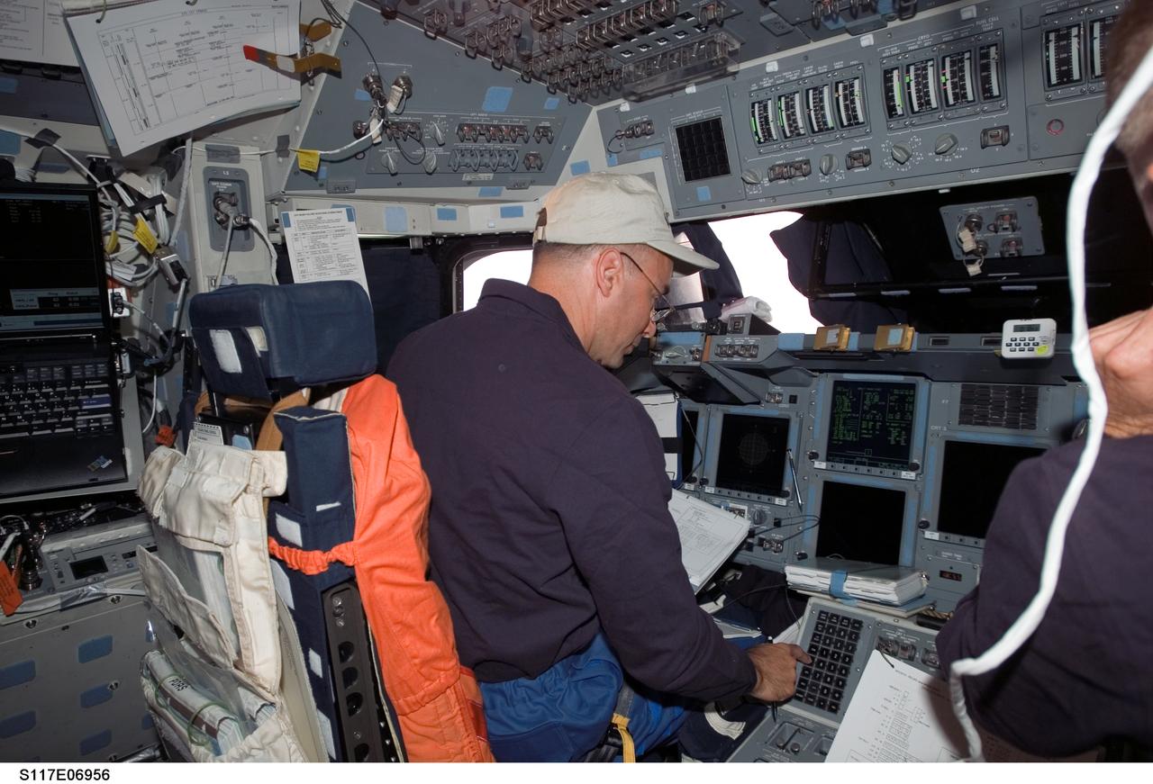 S117-E-06956 (10 June 2007) --- Astronaut Lee Archambault, STS-117 pilot, occupies the commander's station on the flight deck of Space Shuttle Atlantis during rendezvous and docking operations with the International Space Station.