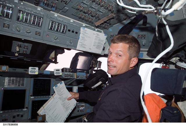 NASA image: Swanson looks at crew procedures in the FD on STS-117 Space Shuttle Atlantis