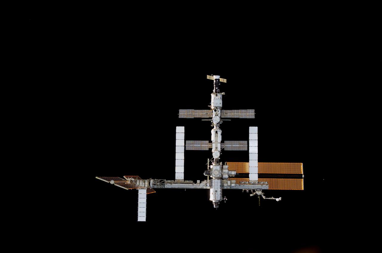 S117-E-06966 (10 June 2007) --- The International Space Station was photographed by one of the STS-117 crewmembers as Space Shuttle Atlantis (out of frame) approached the station during rendezvous and docking activities on flight day three. Docking occurred 2:36 p.m. (CDT) on June 10, 2007.