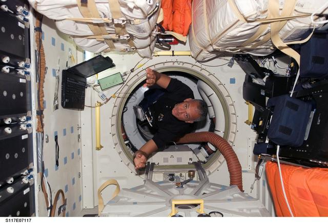 NASA image: Olivas floats through hatch to the MDDK of STS-117 Space Shuttle Atlantis during Joint Operations
