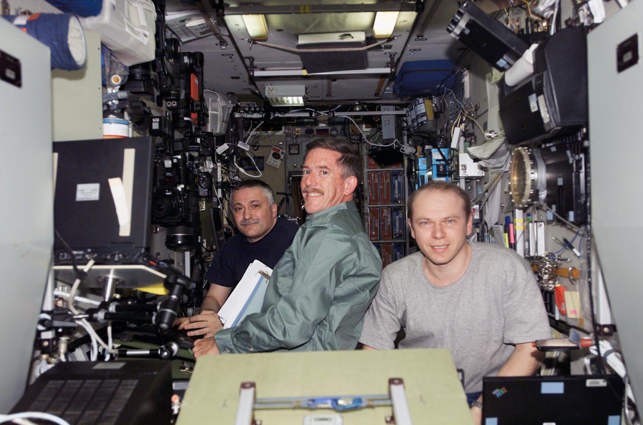 S117-E-07124 (12 June 2007) --- Astronaut Jim Reilly (center), STS-117 mission specialist; cosmonauts Fyodor N. Yurchikhin (left) and Oleg V. Kotov, Expedition 15 commander and flight engineer, respectively, representing Russia's Federal Space Agency, work tasks in the Zvezda Service Module of the International Space Station while Space Shuttle Atlantis was docked with the station.