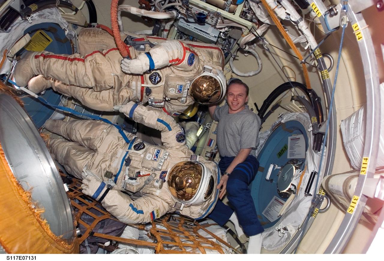 S117-E-07131 (12 June 2007) --- Cosmonaut Oleg V. Kotov, Expedition 15 flight engineer representing Russia's Federal Space Agency, poses with two Russian Orlan spacesuits in the Pirs Docking Compartment of the International Space Station while Space Shuttle Atlantis was docked with the station.