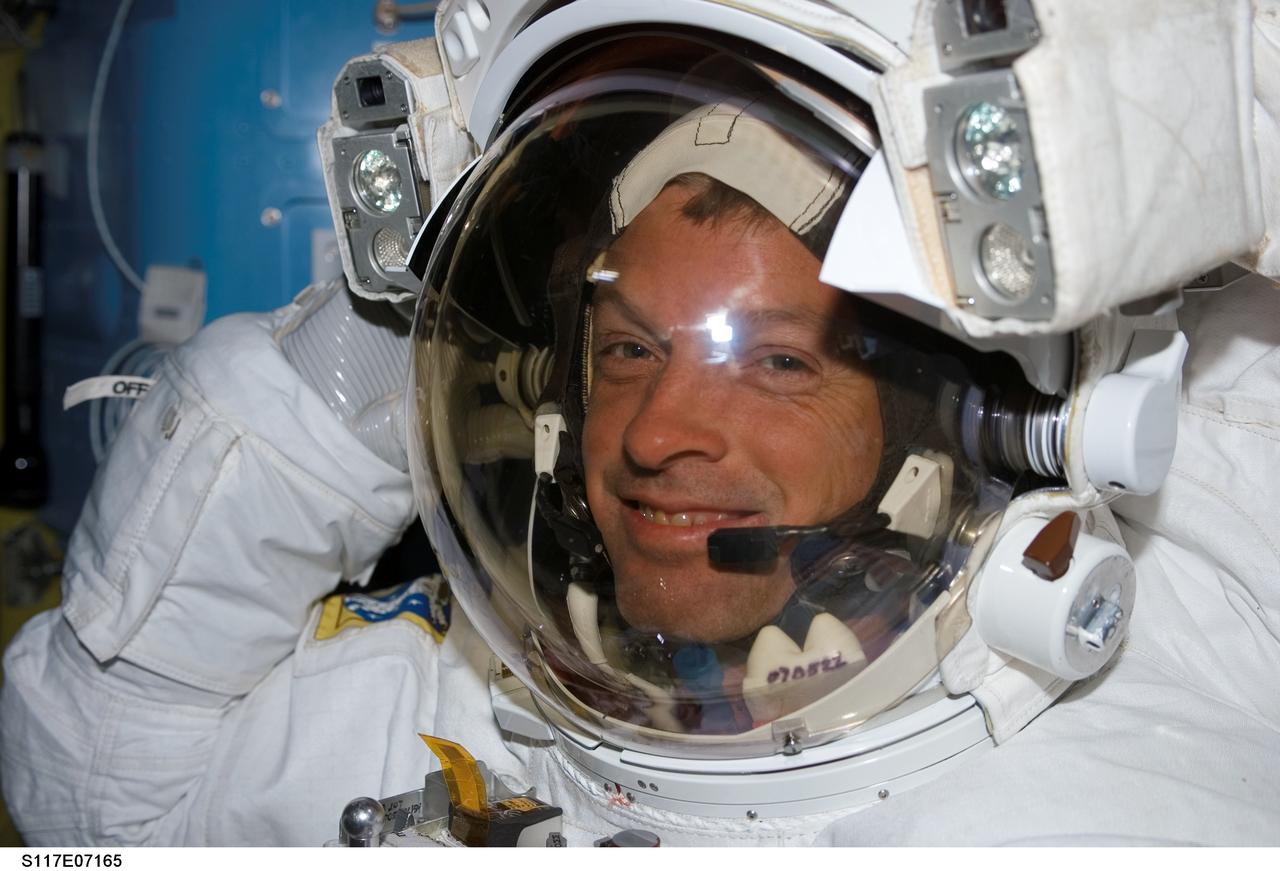 S117-E-07165 (13 June 2007) --- Attired in his extravehicular mobility unit (EMU) spacesuit, astronaut Steven Swanson, STS-117 mission specialist, prepares for the mission's second session of extravehicular activity (EVA) in the Quest Airlock of the International Space Station while Space Shuttle Atlantis was docked with the station.