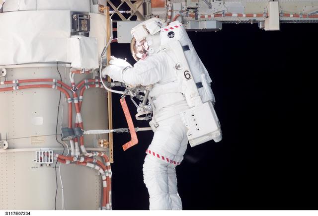 NASA image: Swanson prepares to retract the P6 Truss STBD SAW during EVA 2