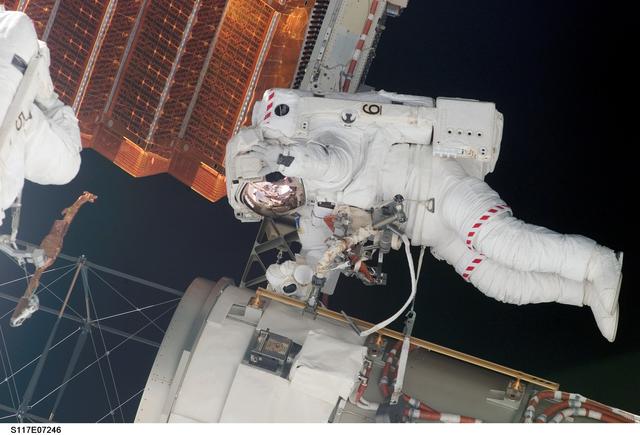 NASA image: Swanson and Forrester prepare to retract the P6 Truss STBD 2B SAW during EVA 2